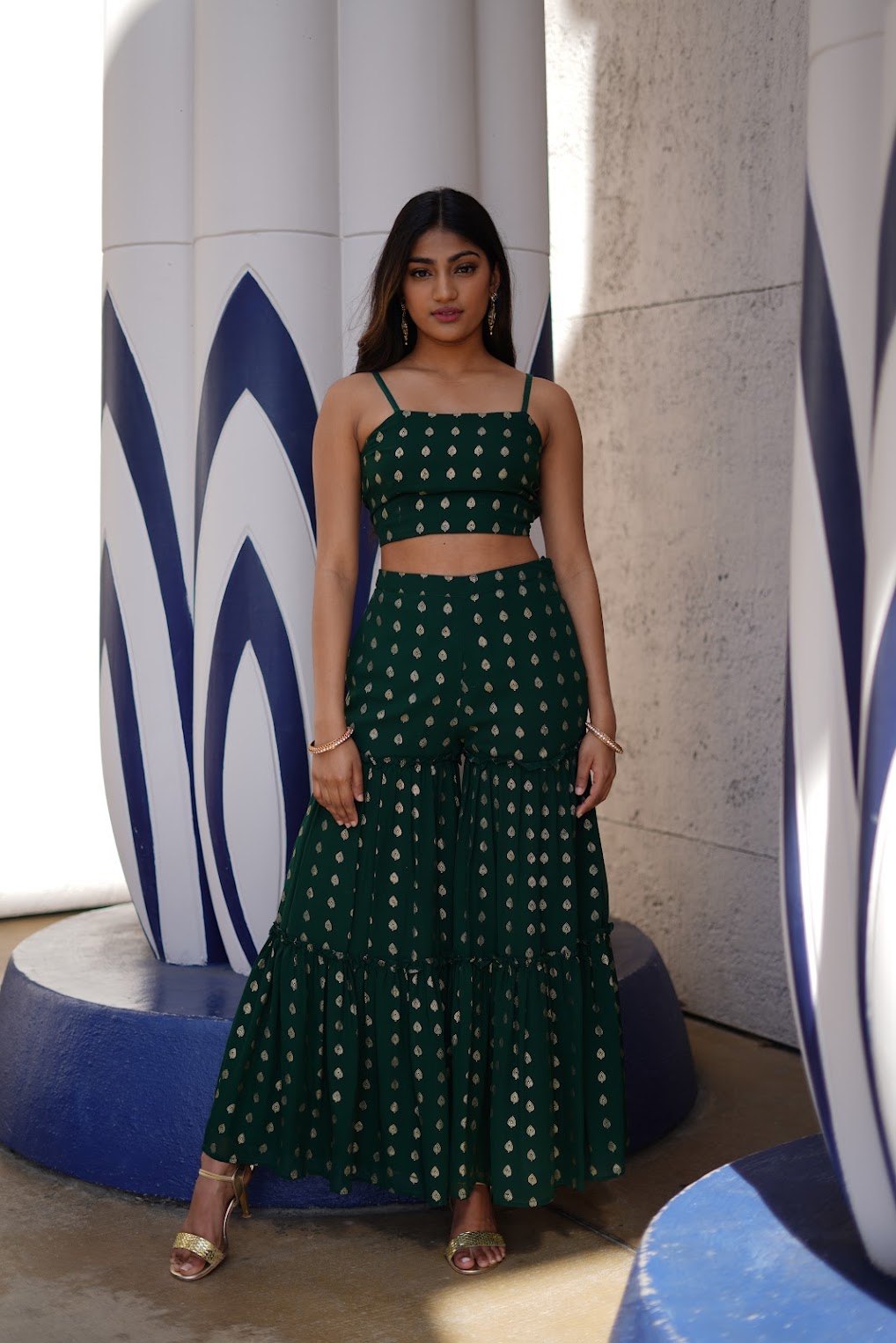 Mahika Valluri in a green gold-print crop top and palazzo pants