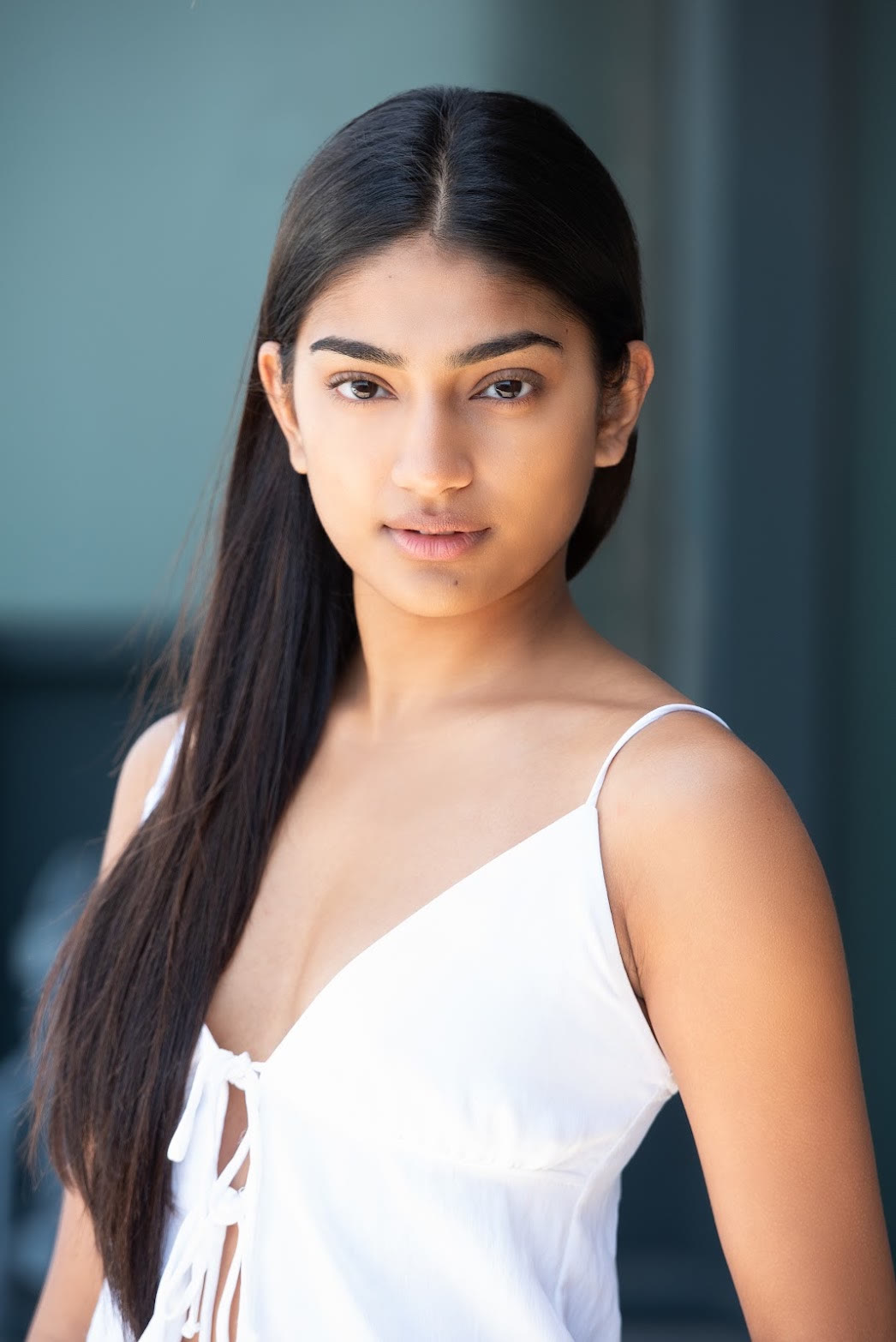 Mahika Valluri acting headshot, close portrait in a white top